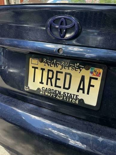 Funny New Jersey vanity plate reading TIRED AF on a Toyota, relatable commuter plate