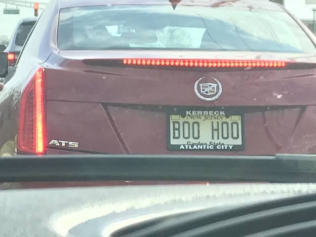 Funny New Jersey vanity plate reading BOO HOO in a car window, a sassy joke plate